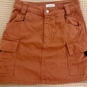 Topshop terracotta cargo mini skirt is a utilitarian-style denim skirt